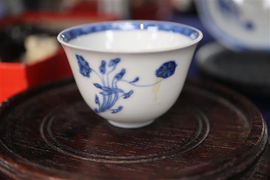 An 18th century Chinese blue and white tea bowl and saucer, and a similar bowl and two hardwood stands